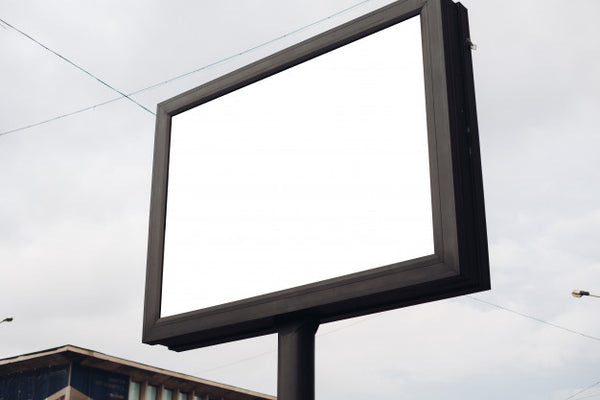 Free A Large Billboard With Interesting Information And Advertising On It Installed Along A Wide Street In The City Center Psd