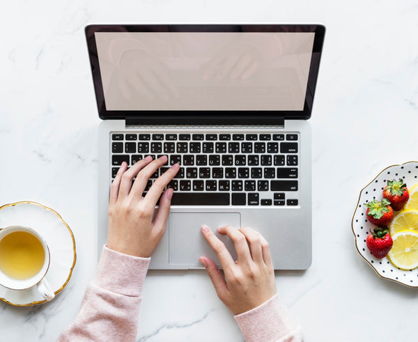 Free Aerial View Of Woman Using A Laptop On A Marble Table With Design Space Psd