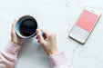 Free Aerial View Of Woman With A Hot Cup Of Coffee And A Smartphone