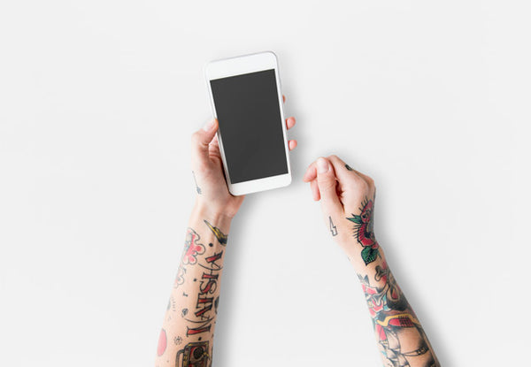 Free Arms With Tattoos Using Smartphone Psd