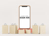 Free Blank Screen Smart Phone Mockup With Shopping Bags Psd