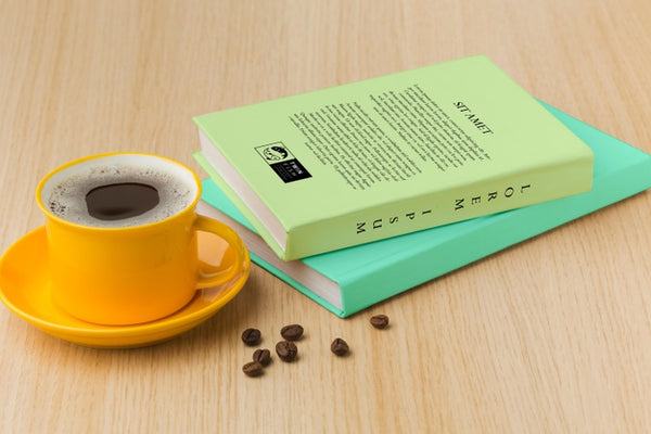 Free Book Cover Arrangement On Wooden Background With Cup Of Coffee Psd