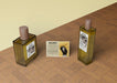 Free Bottles Of Perfume Beside Informational Card Psd
