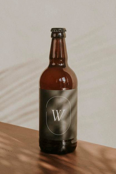 Free Brown Beer Bottle Mockup On Wooden Surface Psd