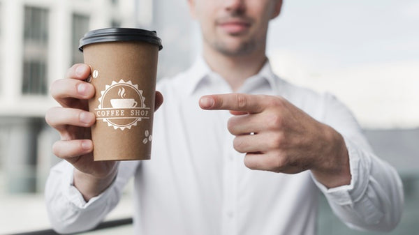 Free Business Man Pointing At A Coffee Cup Mock-Up Psd