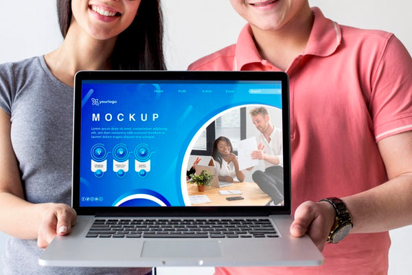 Free Couple Holding A Mock-Up Laptop Psd