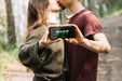 Free Cute Couple In Nature With Smartphone Mock-Up Psd