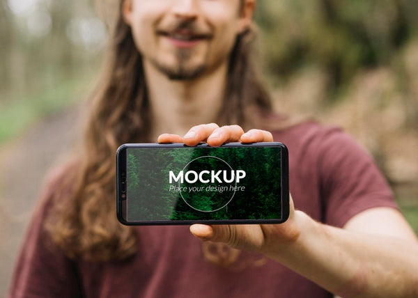 Free Cute Man In Nature With Smartphone Mock-Up Psd