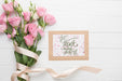 Free Flat Lay Of Frame And Bouquet On Wooden Background Psd