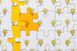 Free Flat Lay Puzzle With Light Bulbs On Yellow Background Psd