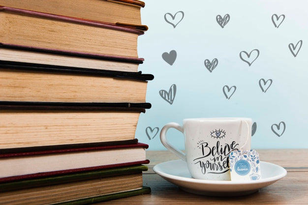 Free Front View Cup Of Coffee With Label And Pile Of Books Psd