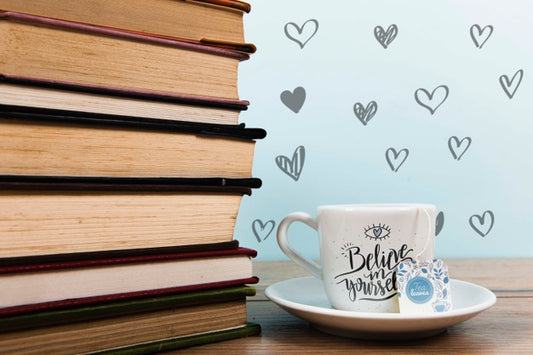 Free Front View Cup Of Coffee With Label And Pile Of Books Psd