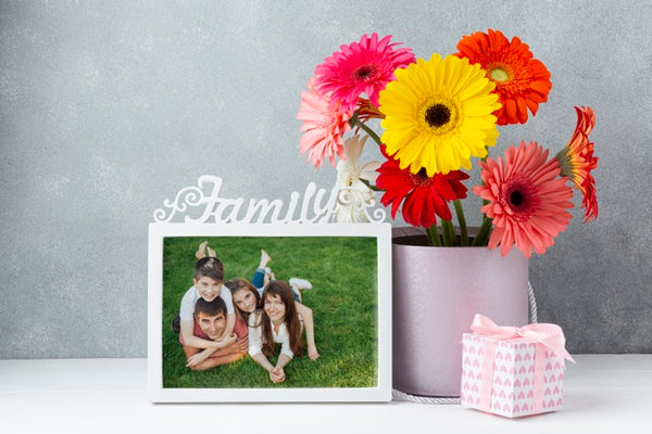 Free Front View Of Flowers On With Frame On Table Psd