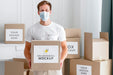 Free Front View Of Male Volunteer With Medical Mask Holding Food Donation Box Psd