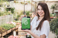 Free Girl Holding Tablet Mockup With Gardening Concept Psd