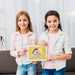 Free Girls Standing And Holding A Tablet Mock-Up Psd