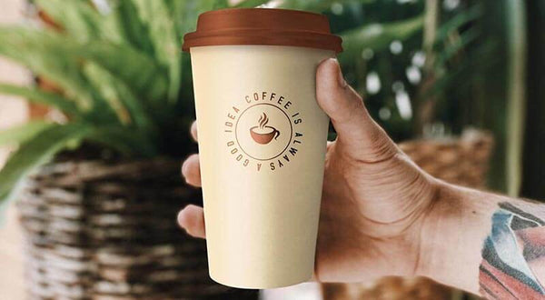 Free Hand Holding Coffee Cup Mockup Psd