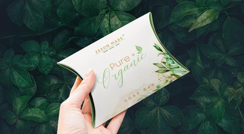 Free Hand Holding Pillow Packaging Box Mockup Psd