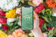Free Hand Holding Smartphone Mockup Above Flowers Psd