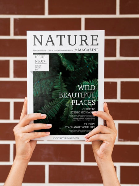 Free Hands Holding A Nature Magazine Mock Up Psd