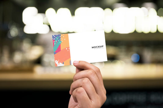 Free Holding Up A Business Card Mockup Psd