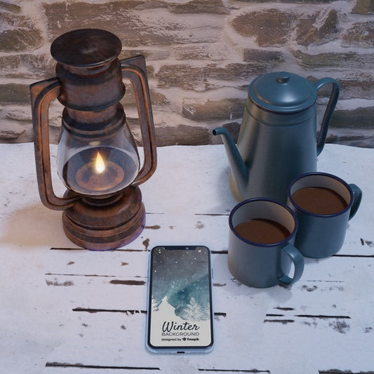 Free Lantern And Kettle With Hot Tea Beside Mobile Psd