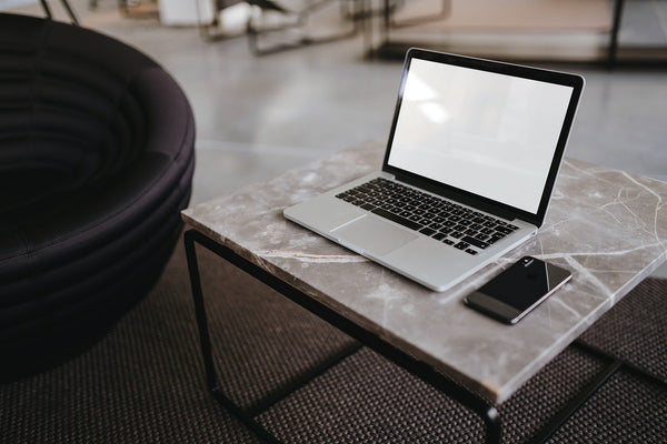 Free Laptop And A Phone On A Marble Table