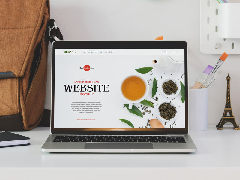 Free Laptop Beside Bag Website Mockup