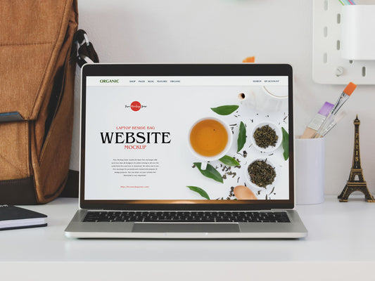 Free Laptop Beside Bag Website Mockup