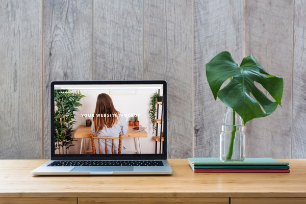 Free Laptop Mockup On Table With Plants Psd