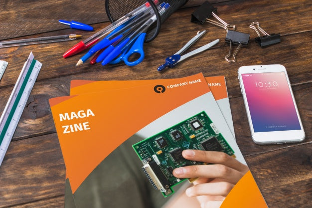 Free Magazine And Smartphone Mockup On Wooden Table With Pens And Rulers Psd