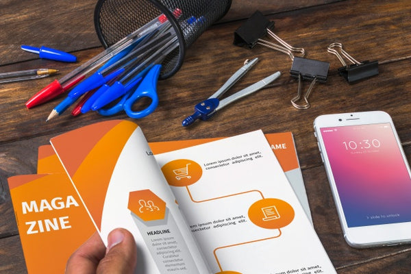 Free Magazine And Smartphone Mockup On Wooden Table With Pens And Rulers Psd