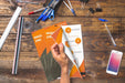 Free Magazine And Smartphone Mockup On Wooden Table With Pens And Rulers Psd