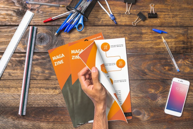 Free Magazine And Smartphone Mockup On Wooden Table With Pens And Rulers Psd