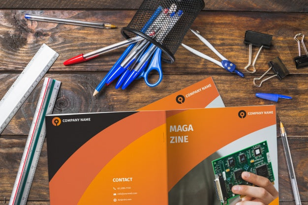 Free Magazine And Smartphone Mockup On Wooden Table With Pens And Rulers Psd