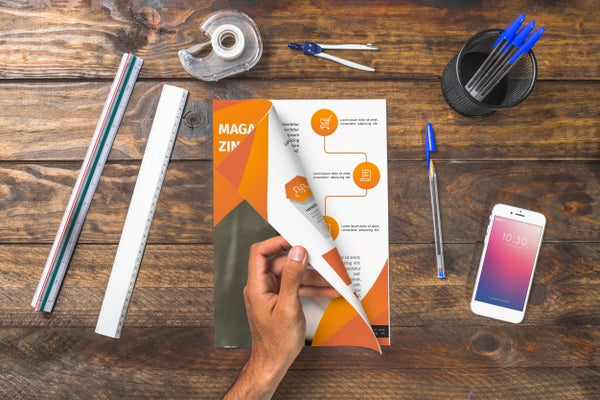 Free Magazine And Smartphone Mockup On Wooden Table With Pens And Rulers Psd