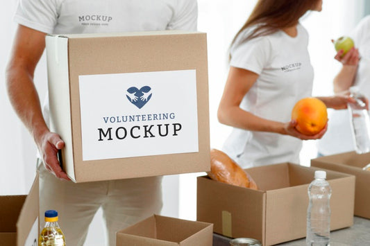 Free Male Volunteer Holding Box Of Food Donation Psd
