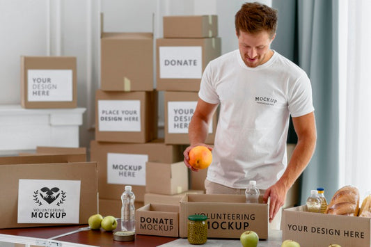 Free Male Volunteer Preparing Donation Box With Provisions Psd