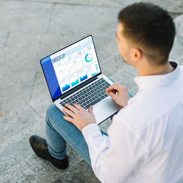 Free Man Holding A Mock-Up Laptop Outdoors Psd