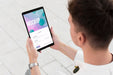 Free Man Holding A Mock-Up Tablet Outside Psd