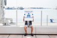 Free Man Holding Poster Mockup In Harbor Psd