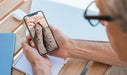 Free Man Looking At Smartphone Mockup Psd