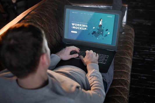 Free Man On The Couch Working From Home On Laptop Psd