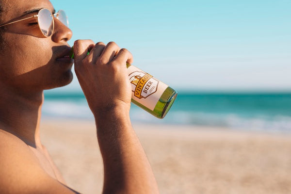 Free Man With Beer Bottle Mockup At The Beach Psd