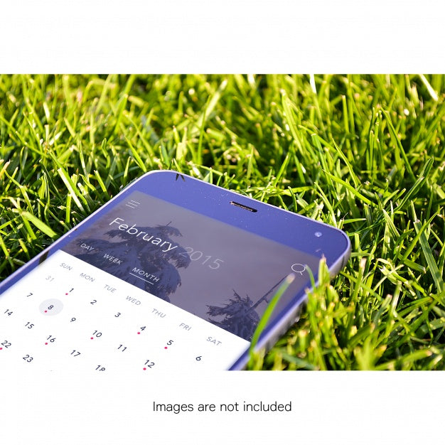 Free Mobile Phone On Grass Mock Up Psd