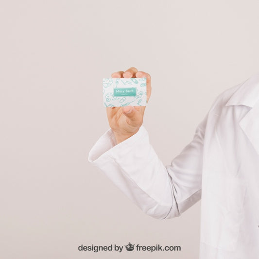 Free Mock Up With Doctor'S Hand Holding A Visiting Card Psd