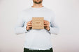 Free Mock Up With Man Holding A Carton Box Psd