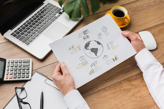 Free Office Desk With Person Holding Sheet Of Paper Mock-Up Psd