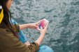 Free Person Using Smartphone Mockup On Sea Background Psd