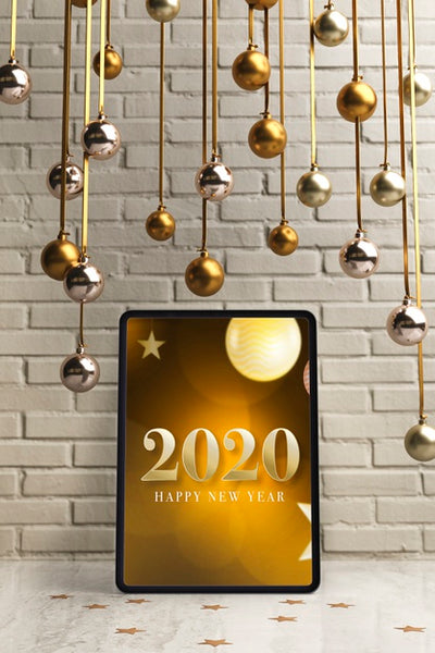 Free Silver And Golden Hanging Globes On Top Of Tablet Psd